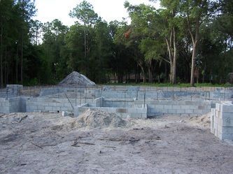 A construction site with a lot of bricks and dirt