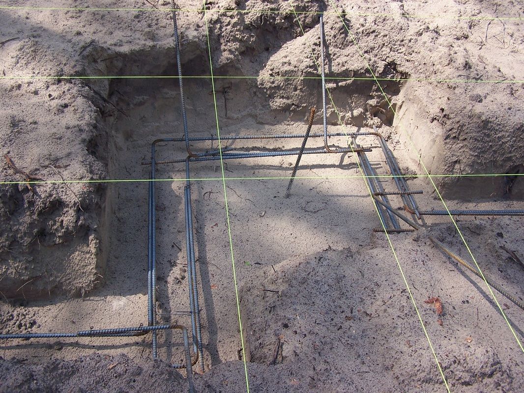 A hole in the ground with a metal frame in it