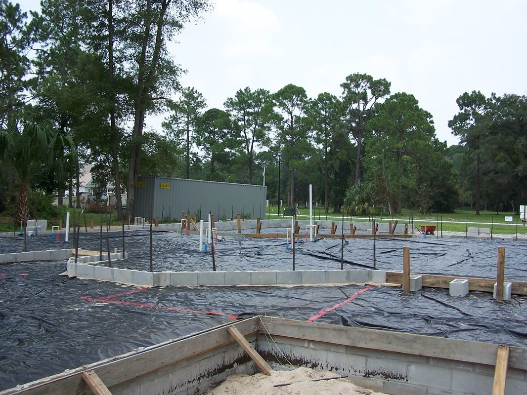 A construction site with a lot of trees in the background