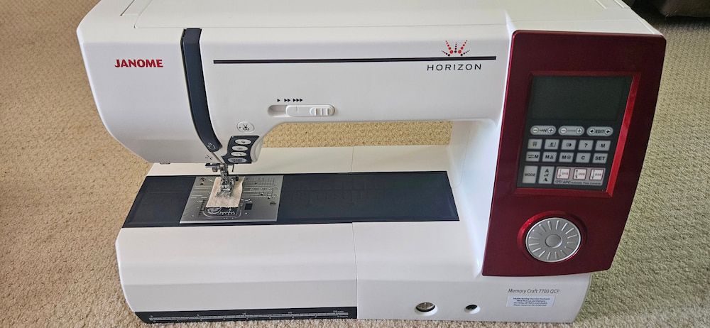 A Janome Sewing Machine is Sitting on a Carpeted Floor — James Hunter Mobile Sewing Machine Mechanic in Battery Hill, QLD