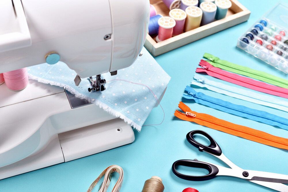 A Sewing Machine is Sitting on Top of a Blue Table  — James Hunter Mobile Sewing Machine Mechanic in Maroochydore, QLD
