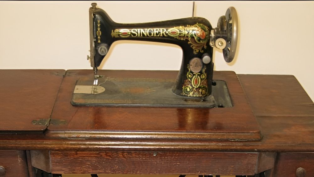 An Old Singer Sewing Machine Sits on a Wooden Table — James Hunter Mobile Sewing Machine Mechanic in Battery Hill, QLD