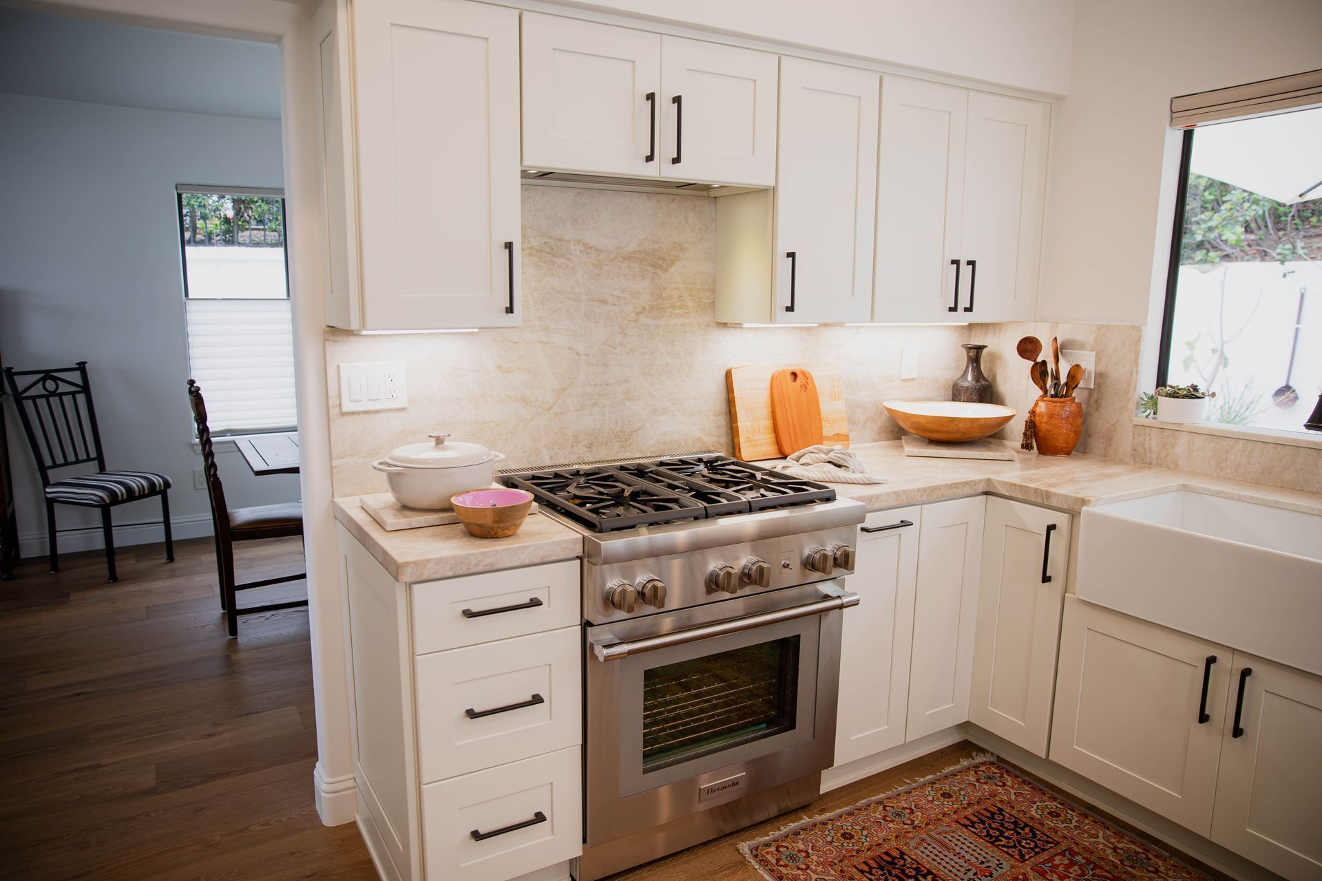 A kitchen with white cabinets and stainless steel appliances.