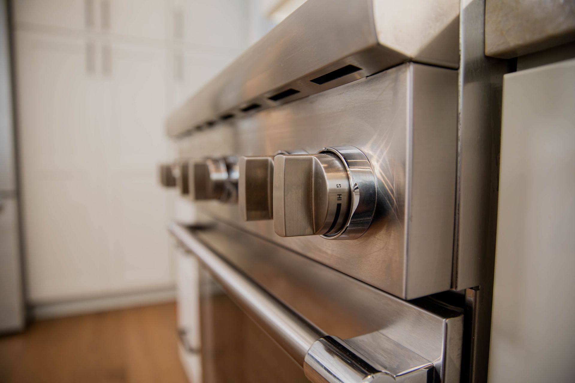 A close up of a stainless steel stove top oven in a kitchen.