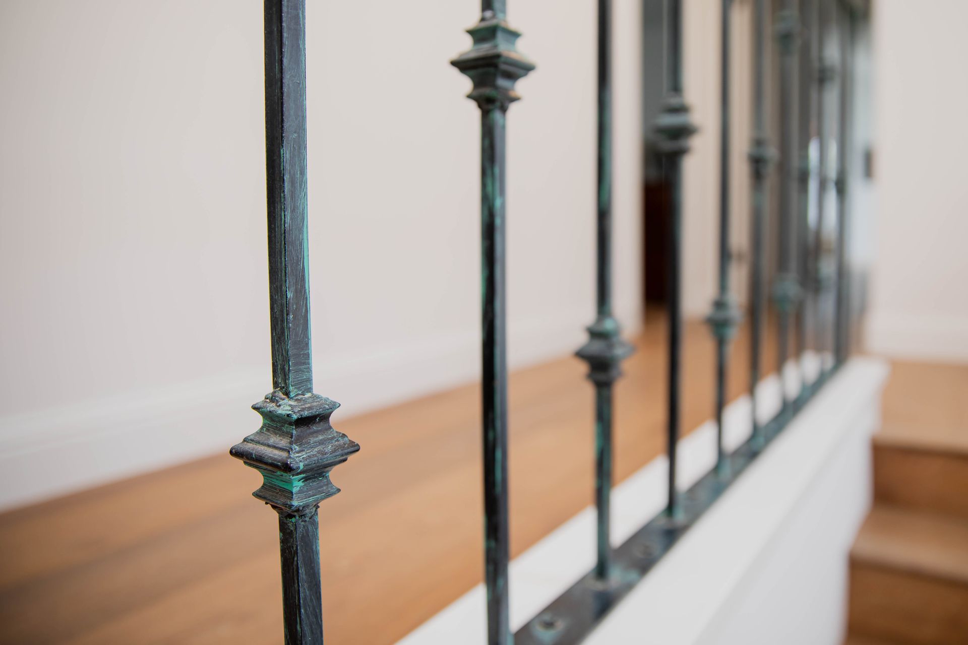 A close up of a wrought iron railing on a staircase.