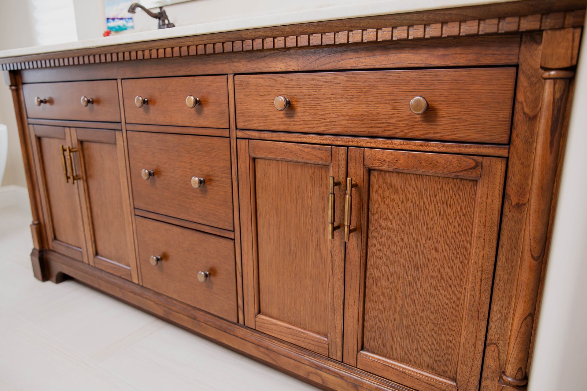 A newly remodeled bathroom vanity with lots of drawers and cabinets