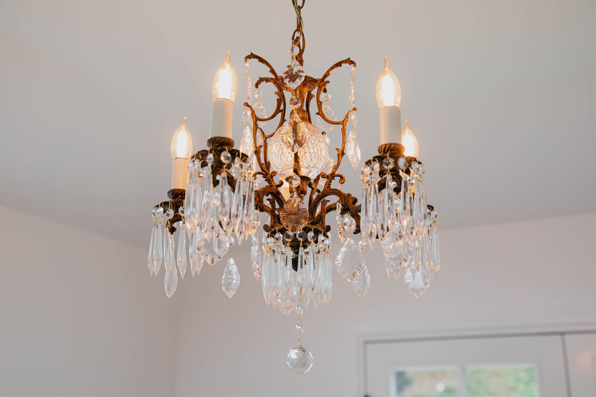 A chandelier is hanging from the ceiling in a room.