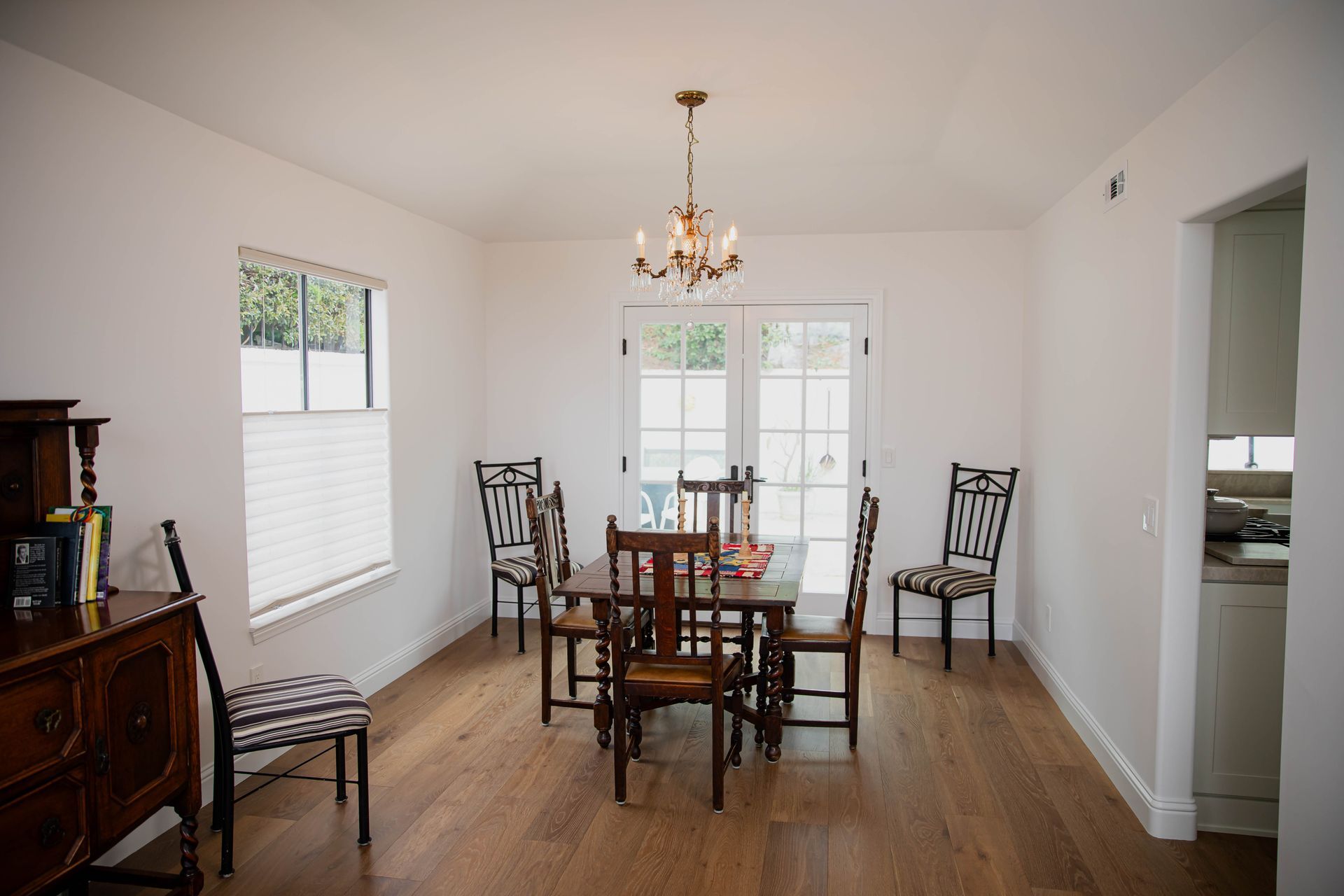 A dining room with a table and chairs and a chandelier