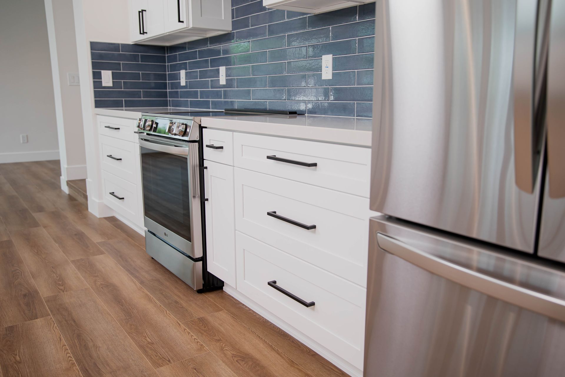 A kitchen with stainless steel appliances and white cabinets