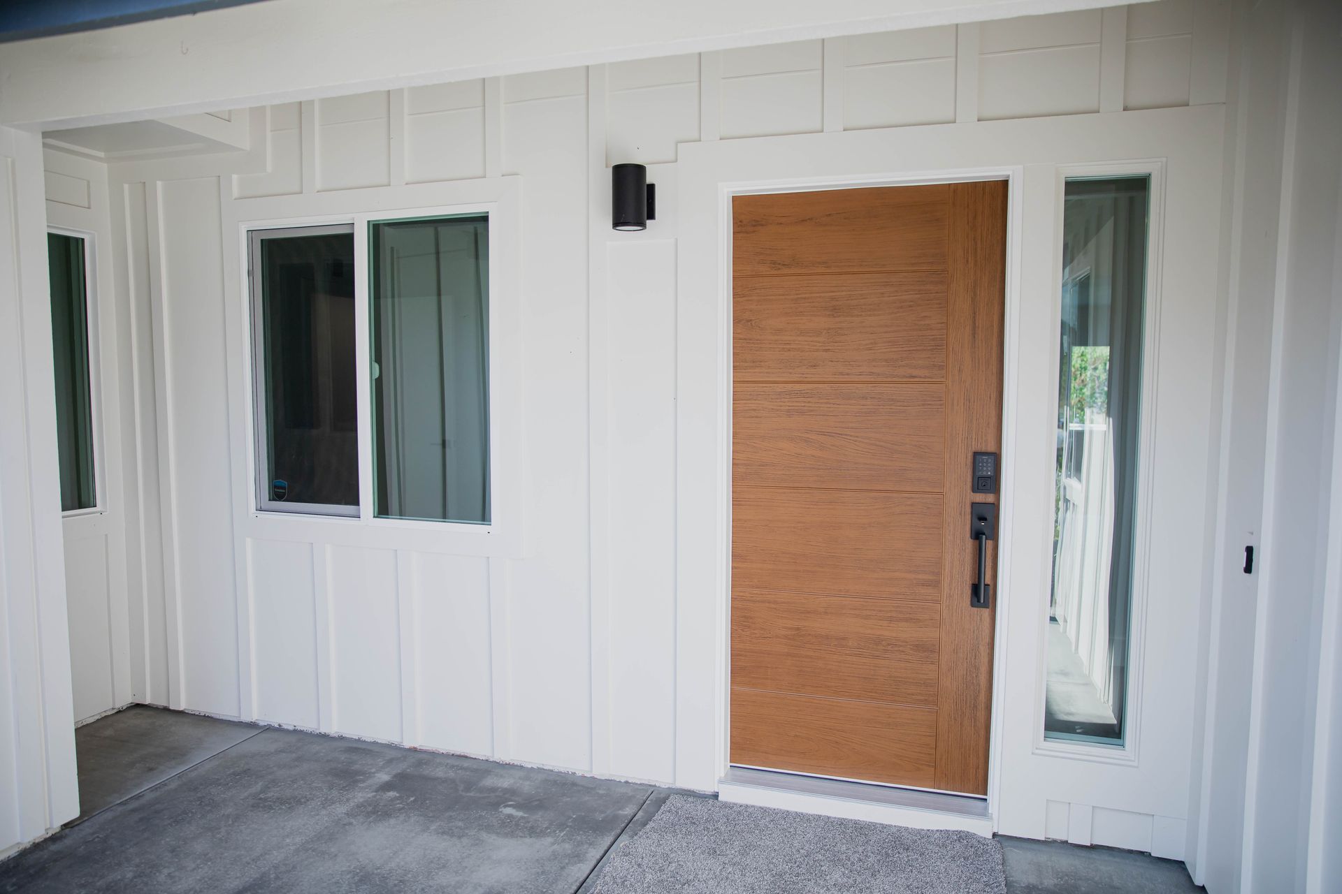 A white house with a wooden door and windows.