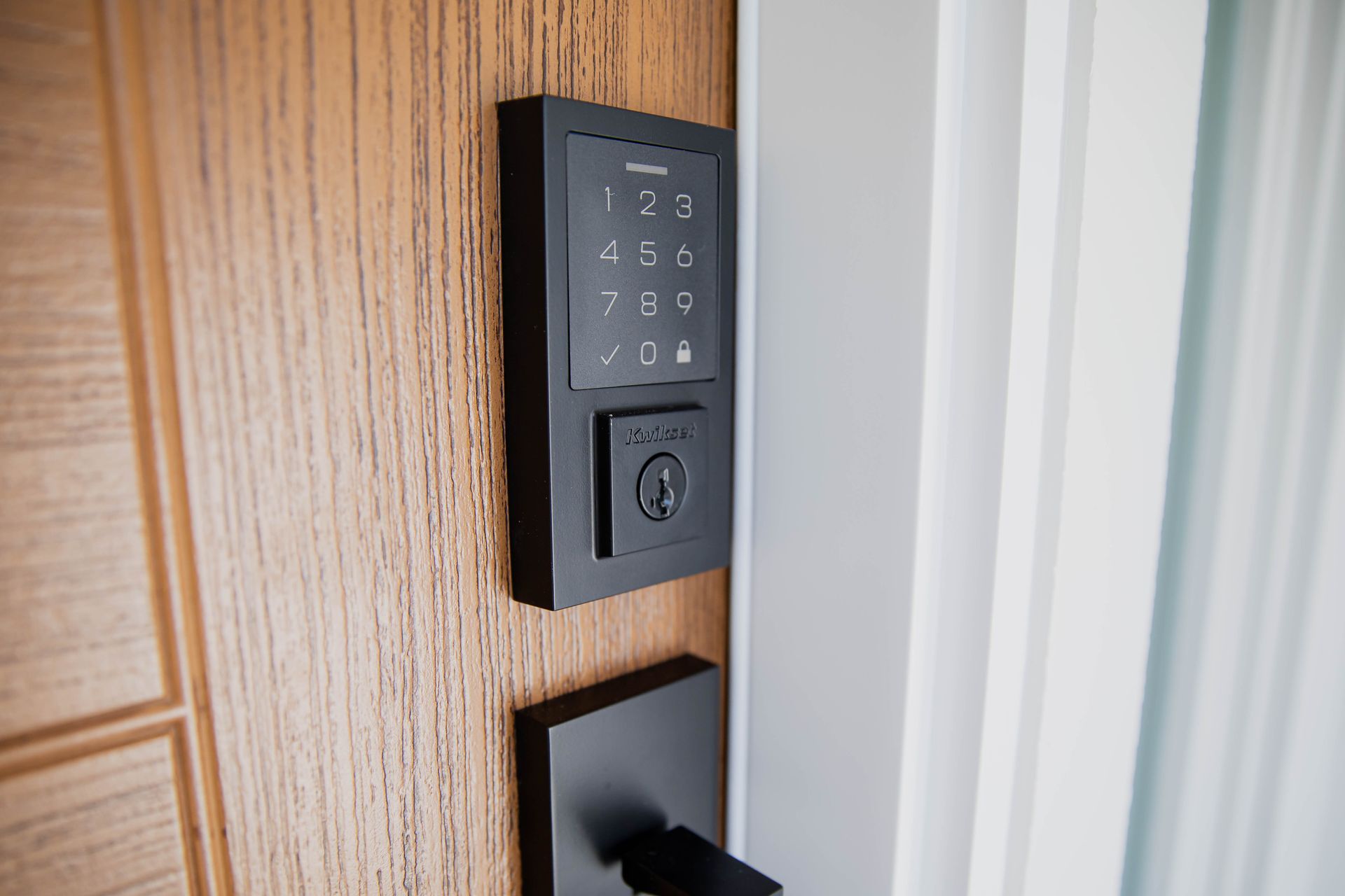 A close up of a door with a keypad on it.