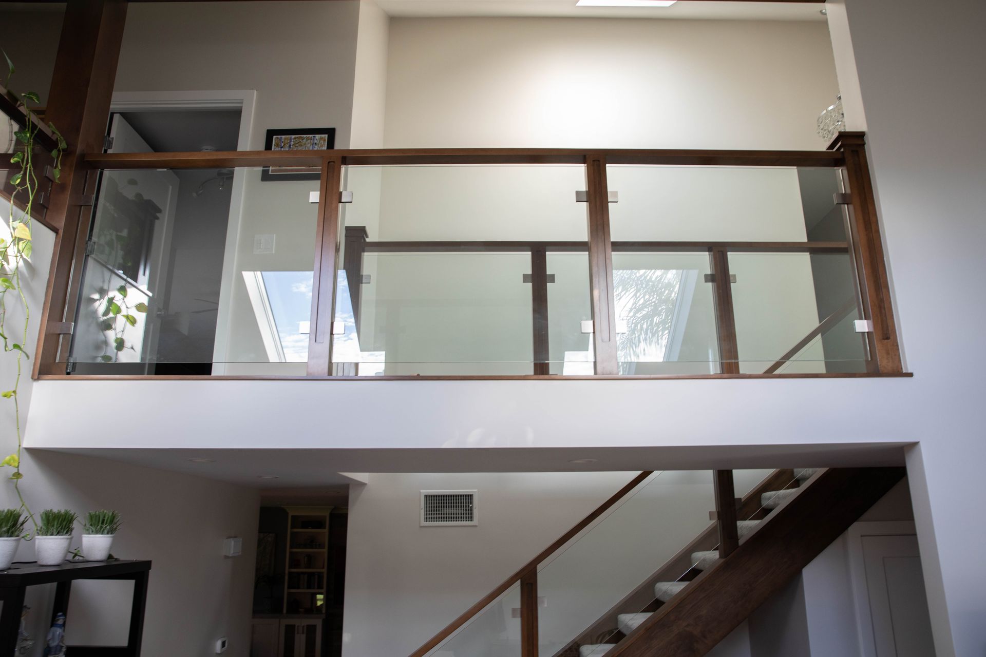 A staircase with a glass railing in a house