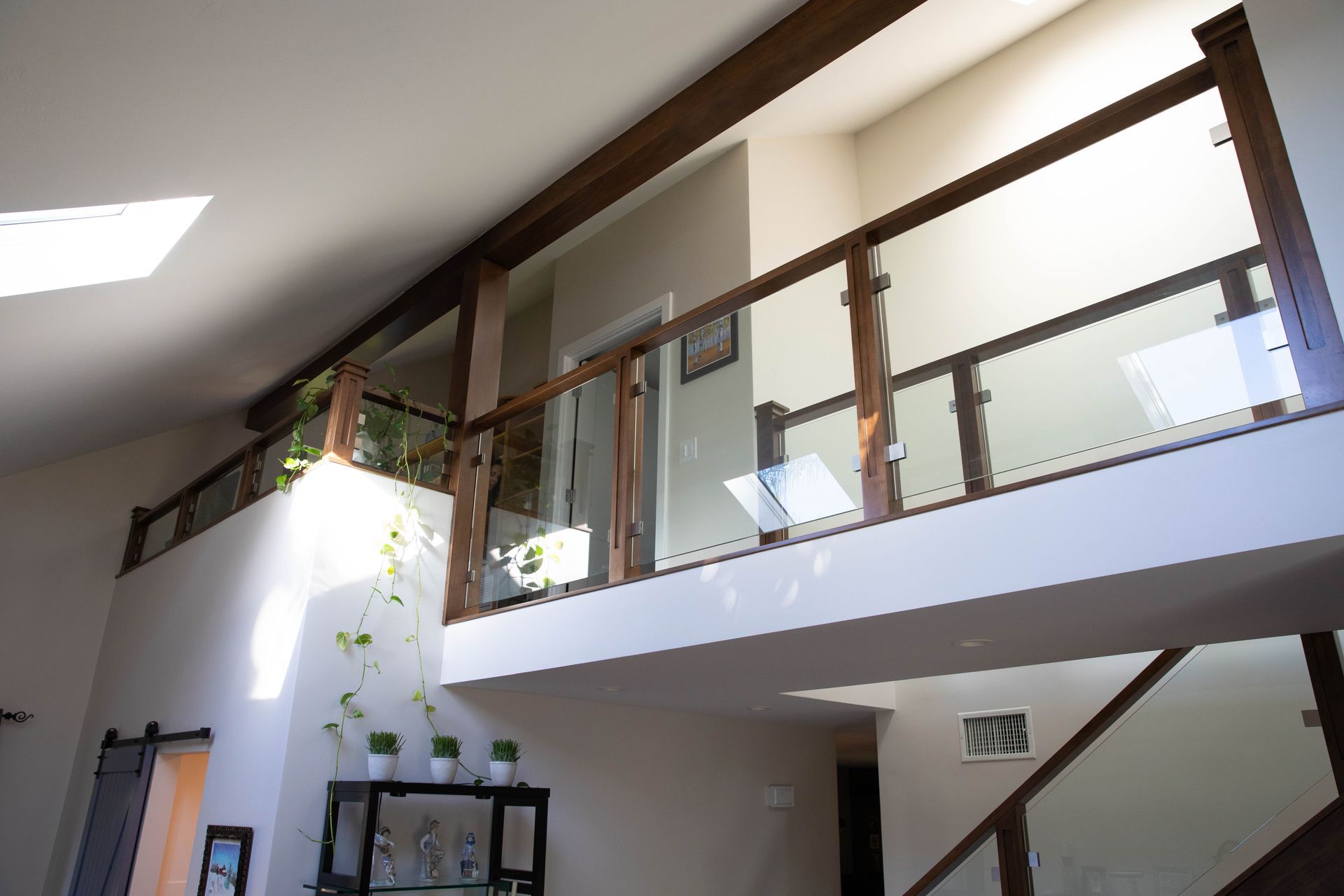 A staircase in a house with a glass railing