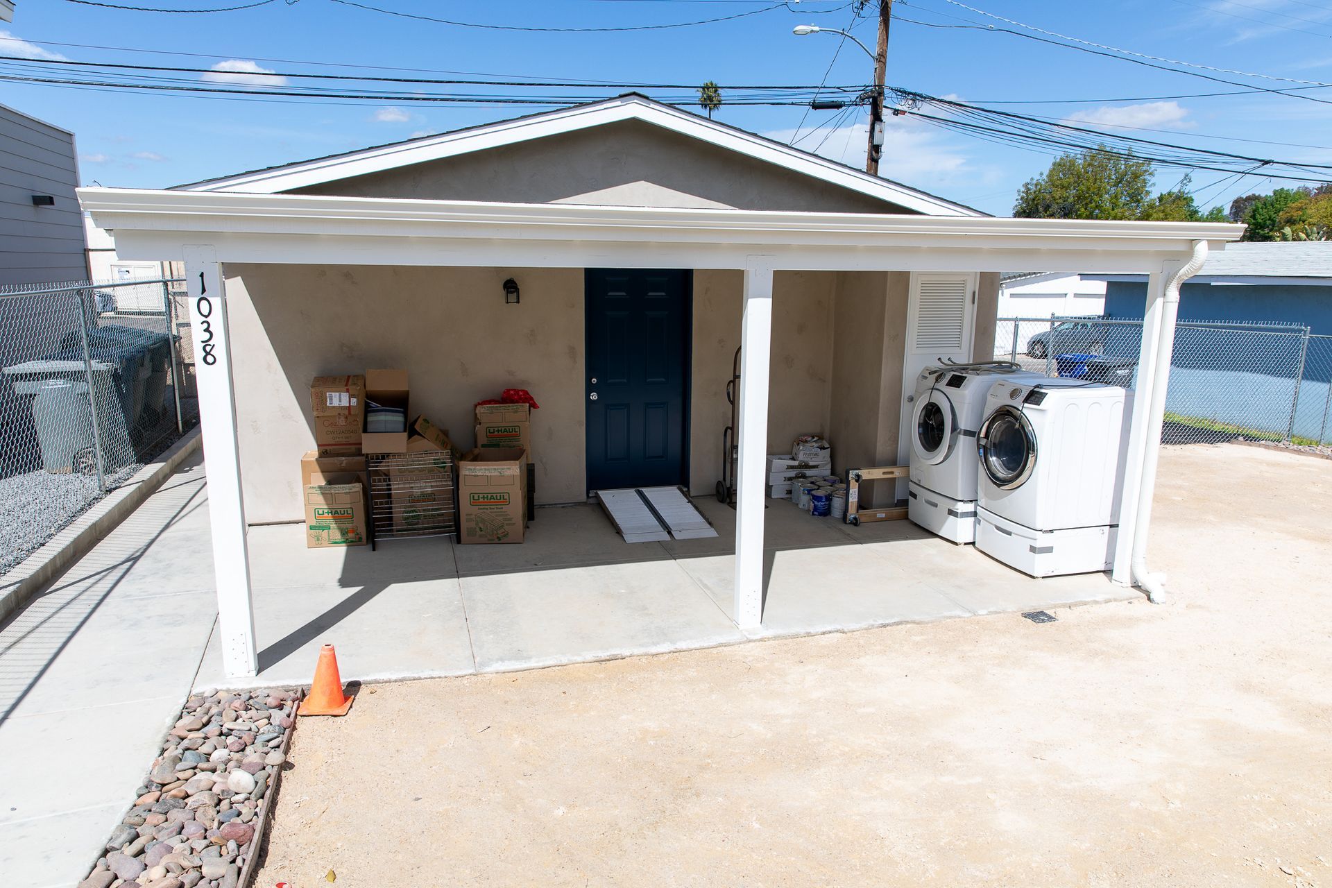 A house with a porch and a washer and dryer in it