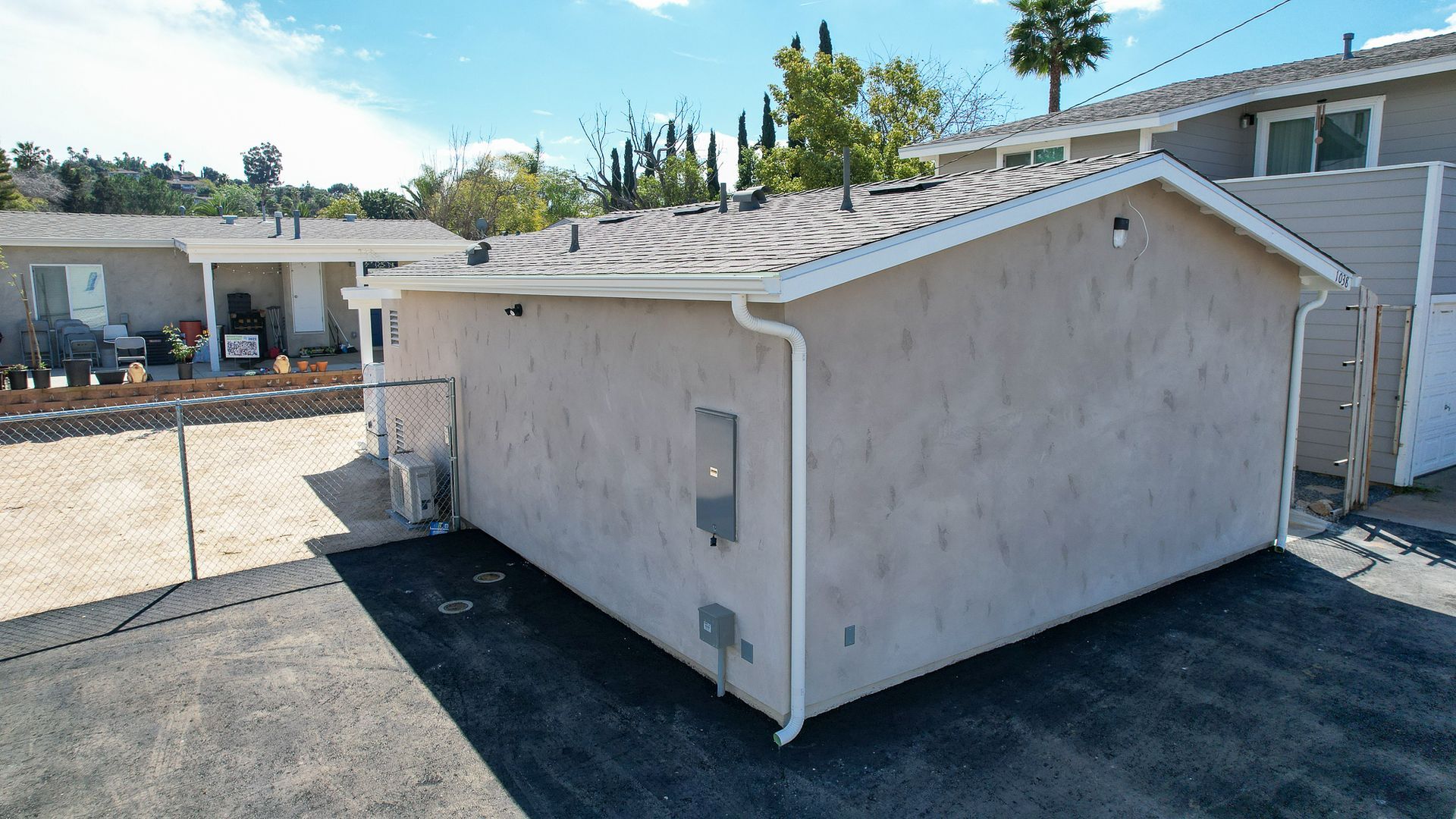 An aerial view of a house with a shed in the backyard.