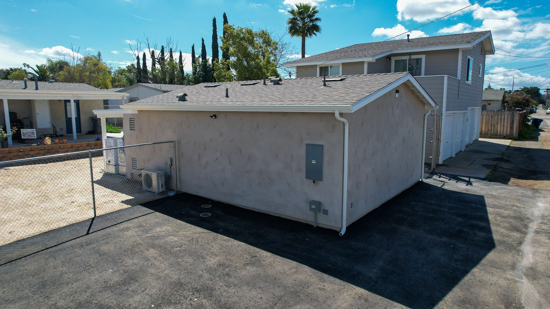 An aerial view of a house with a shed in the backyard.