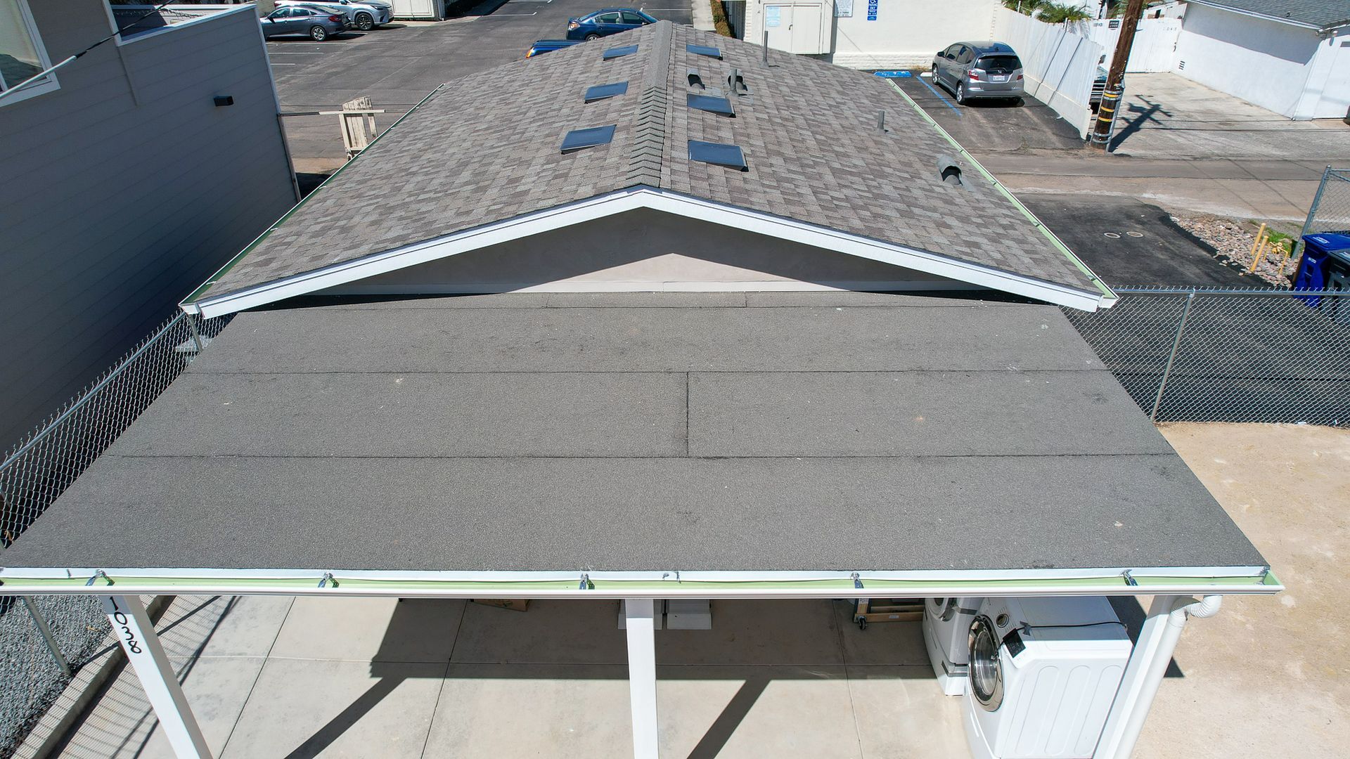 An aerial view of a house with a roof that is being installed.