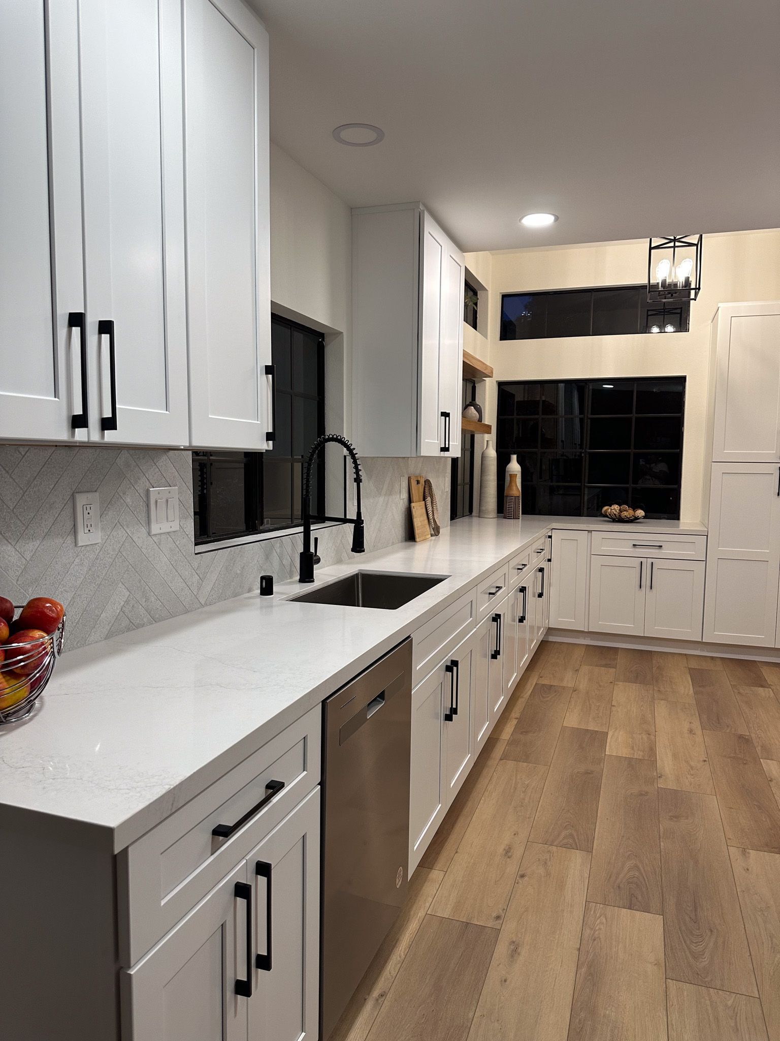 A kitchen with white cabinets and stainless steel appliances