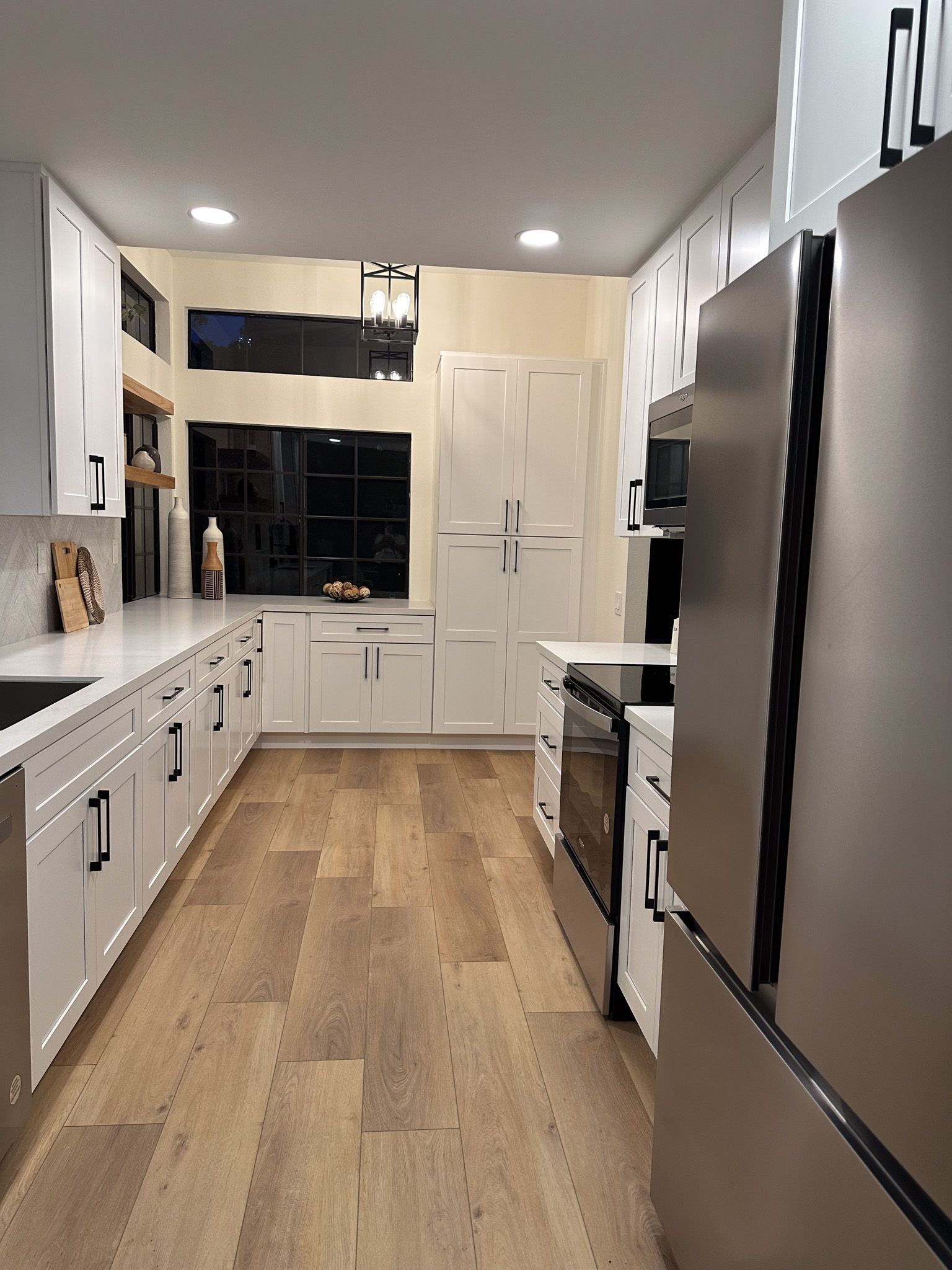 A kitchen with white cabinets and stainless steel appliances.