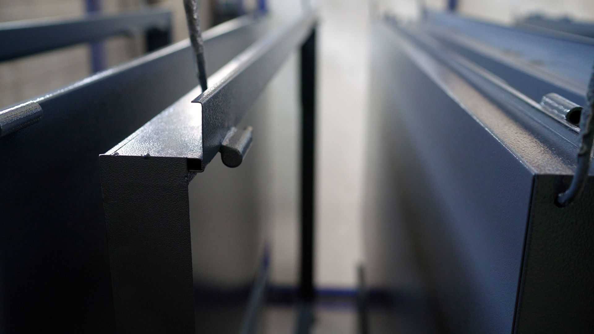 Dark gray metal objects hanging, with a close-up on the edges.