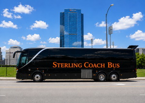 Black Sterling Coach Bus parked by the roadside with a blue high-rise in the background