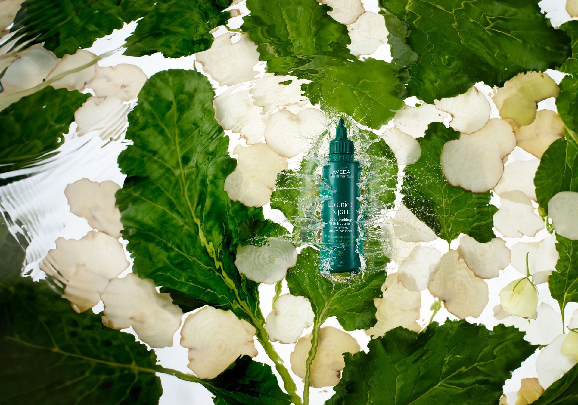 Honey in wooden bowl with a spoon, surrounded by ingredients like lemon and herbs.