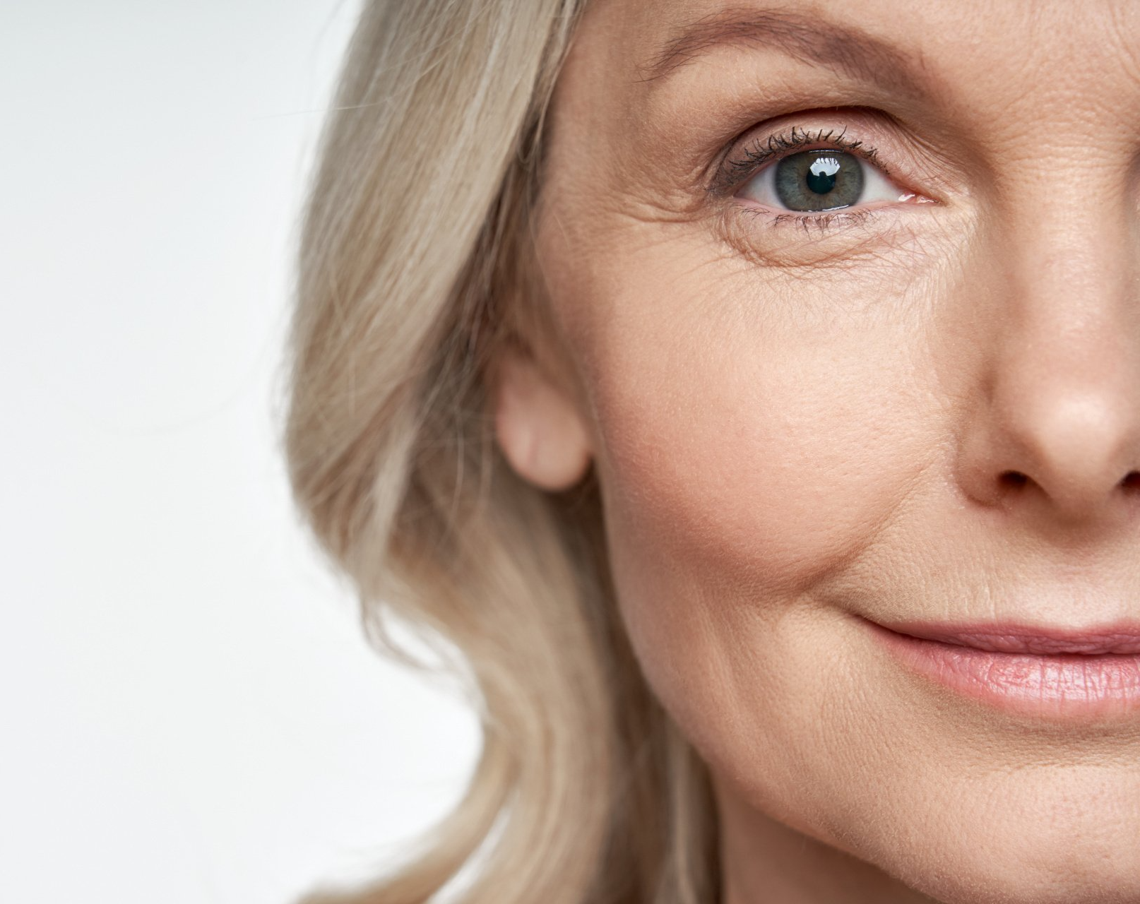 A close up of a woman 's face with a smile on her face.