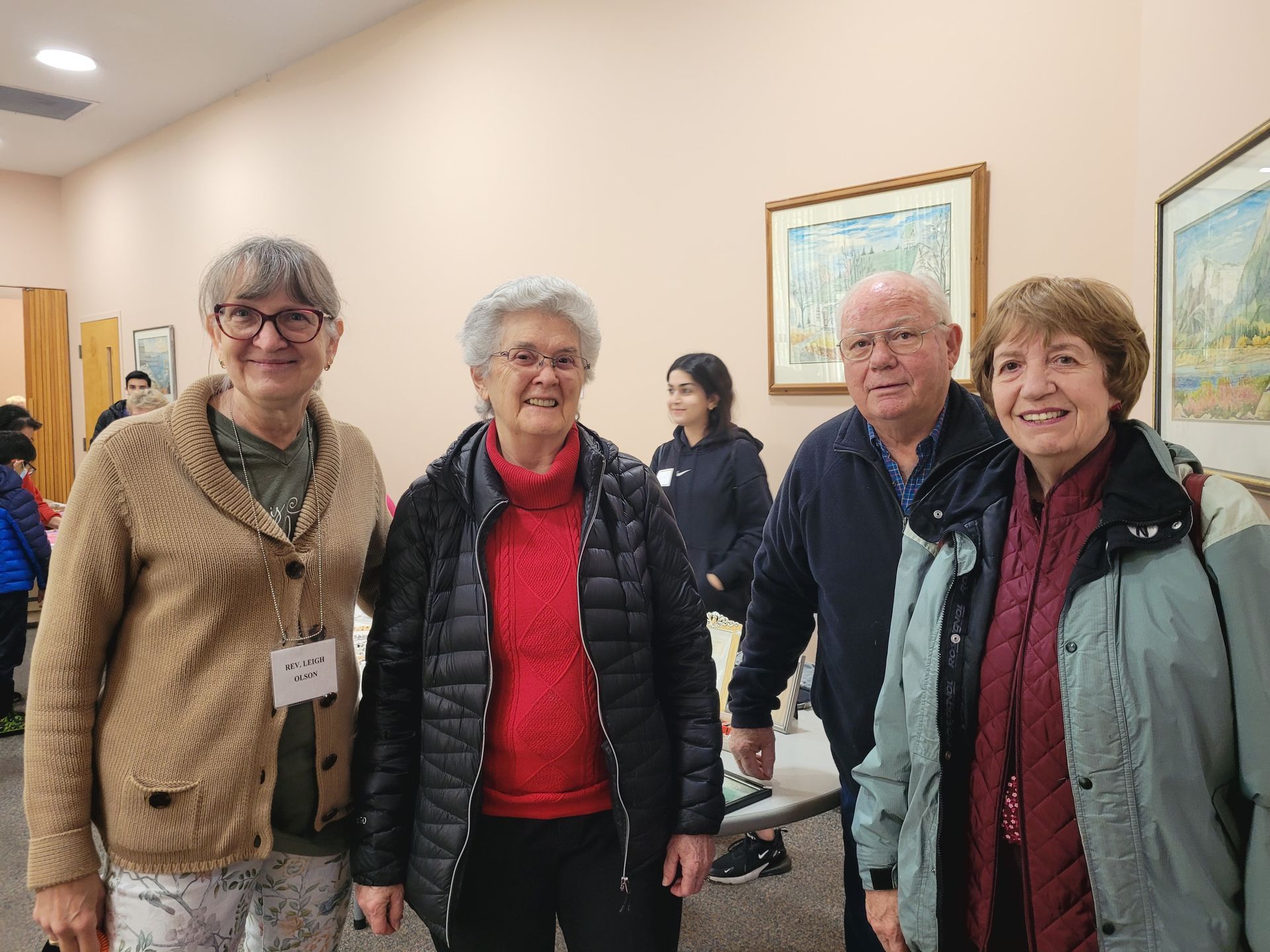 a group of people are posing for a picture in a room .