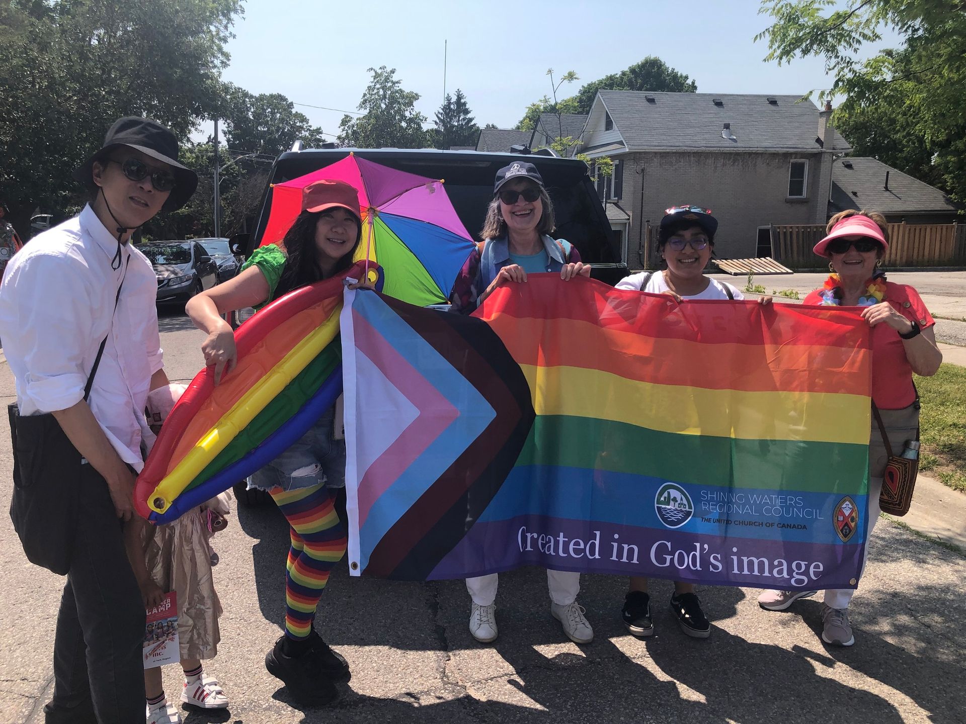 a group of people holding a rainbow flag that says