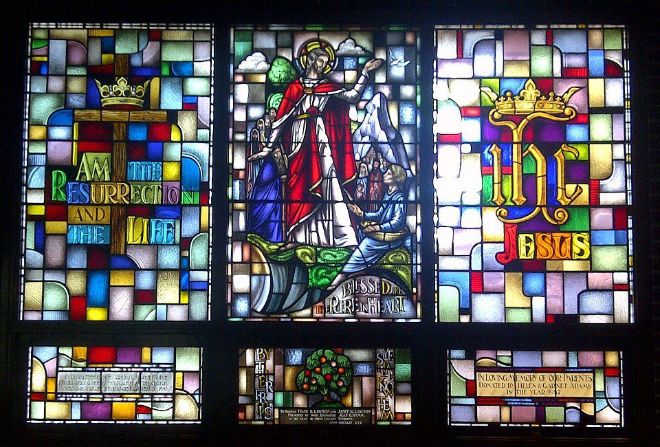 a stained glass window with the word jesus on it