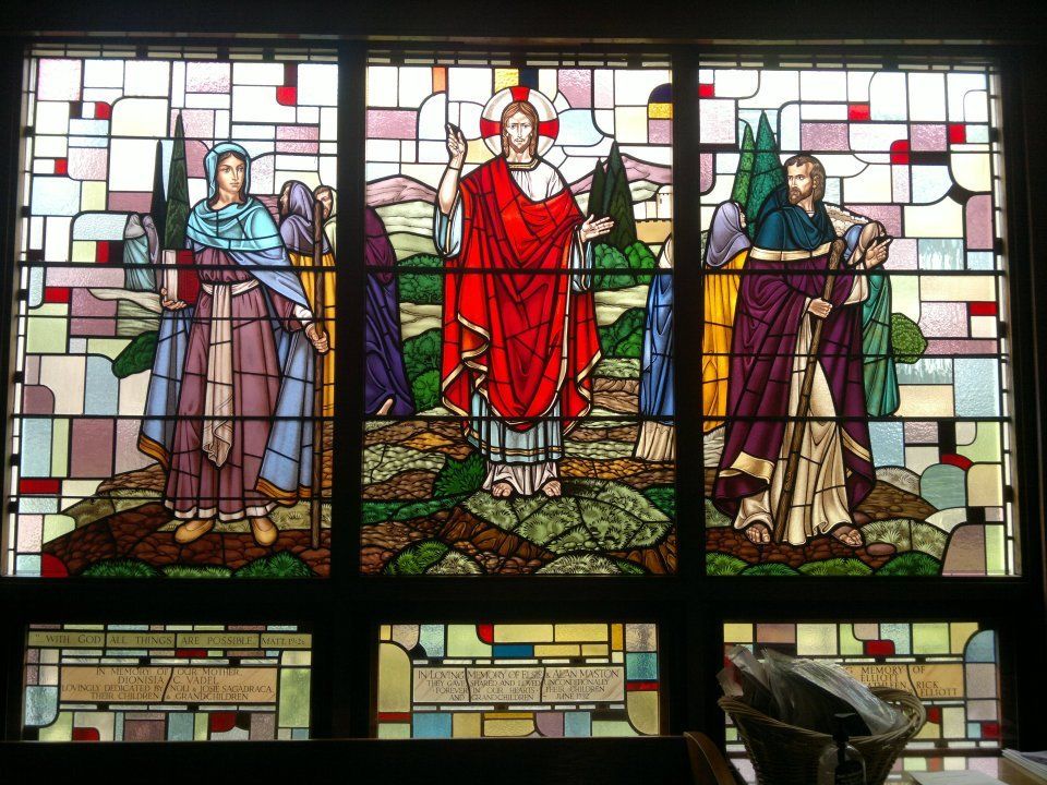 a stained glass window shows jesus and his disciples