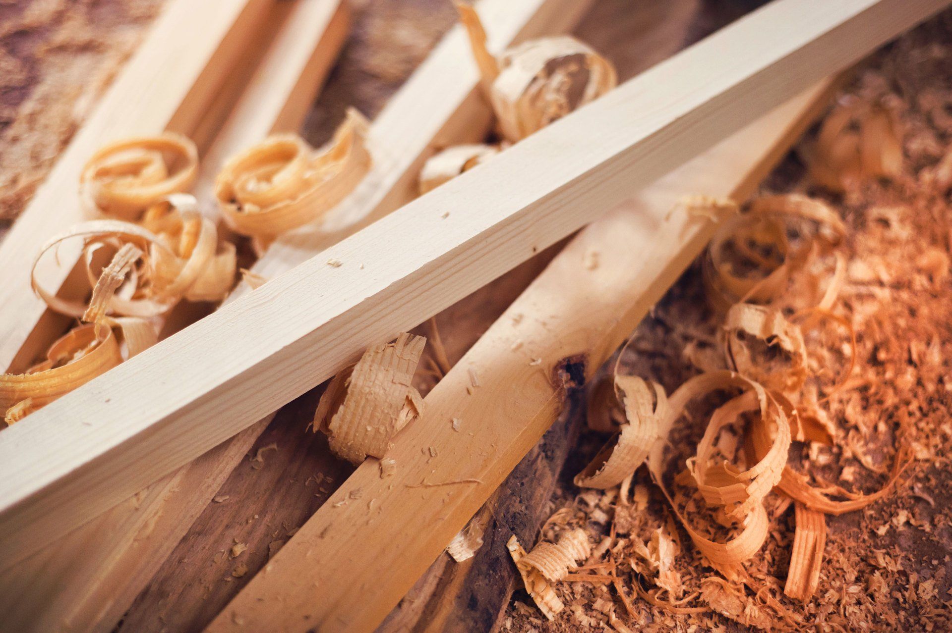 a pile of wood shavings and pieces of wood on a wooden table .