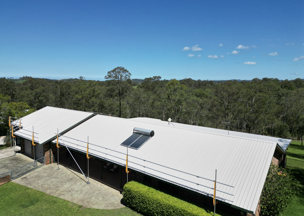 An Aerial View of A House with A Solar Panel on The Roof Before — Bulley Roof Restoration, Painting & Pressure Cleaning in Wingham, NSW