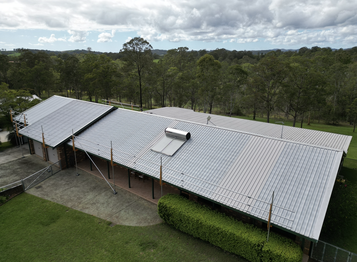 An Aerial View of A House with A Solar Panel on The Roof After — Bulley Roof Restoration, Painting & Pressure Cleaning in Wingham, NSW