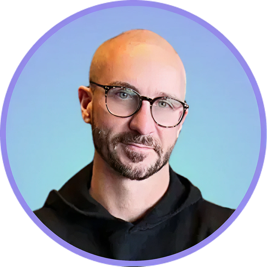 Man with glasses and bald head, smiling, in front of a blue gradient background, wearing black.