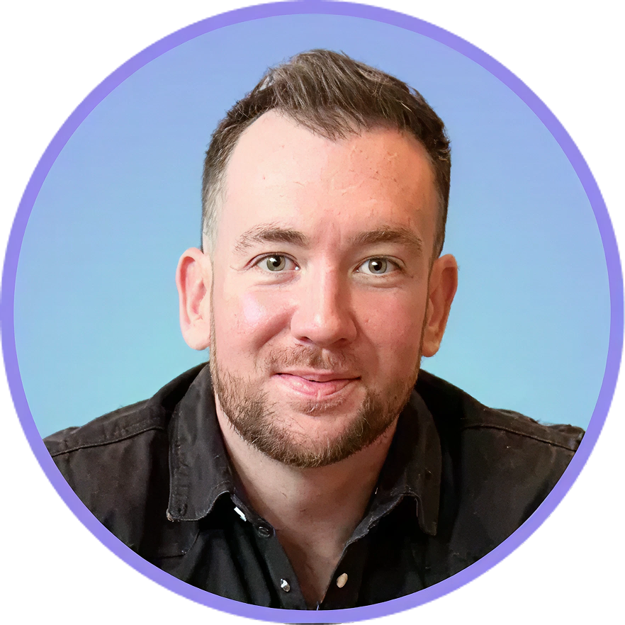 Smiling man with a short beard in a black shirt, set against a light blue gradient background.