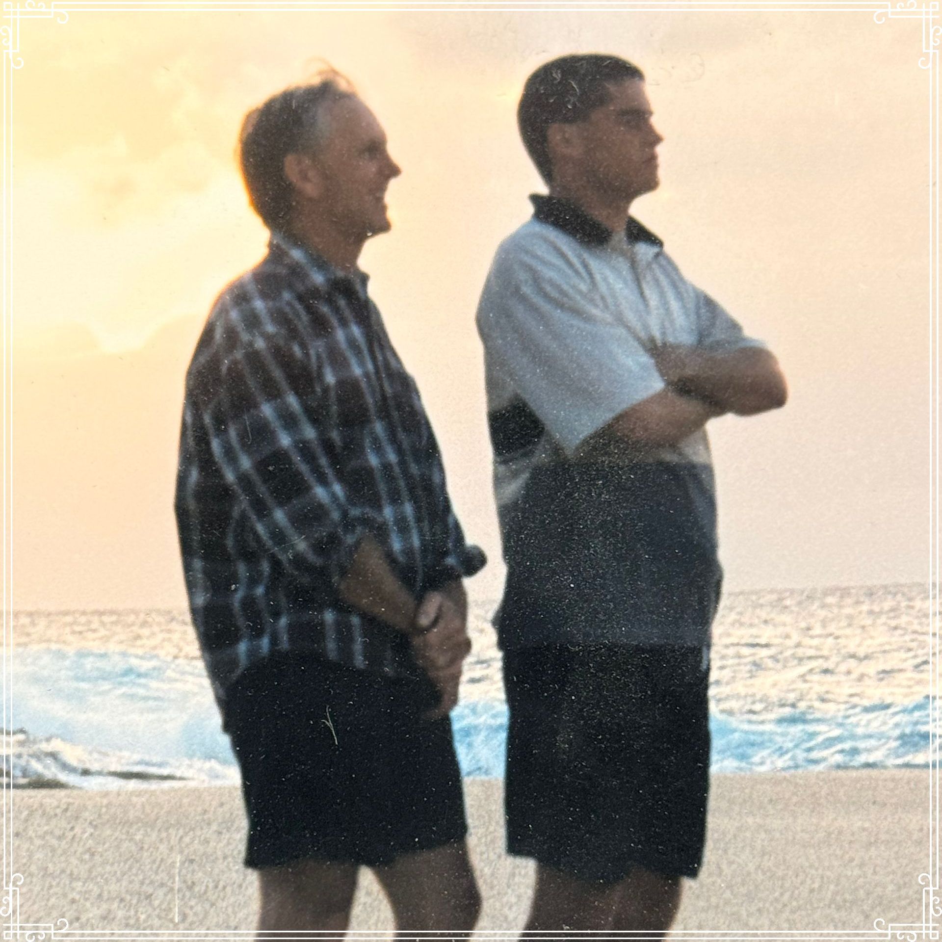 Two men posing for a picture with one wearing a hat that says falcons