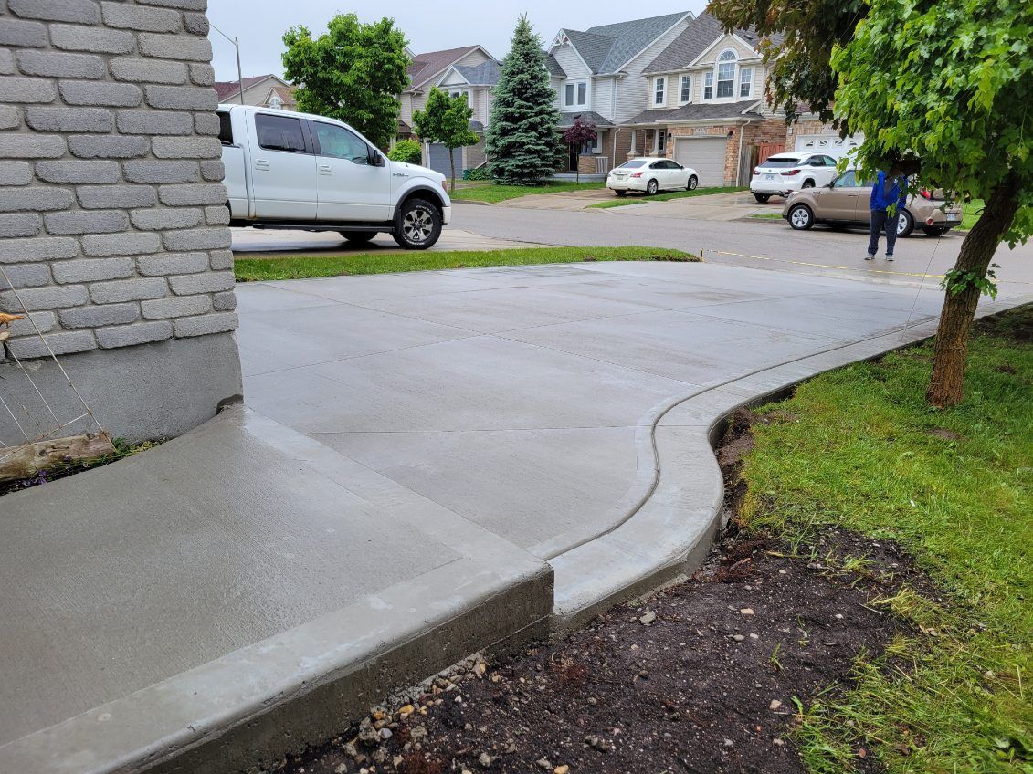 A white truck is parked in the driveway of a house.