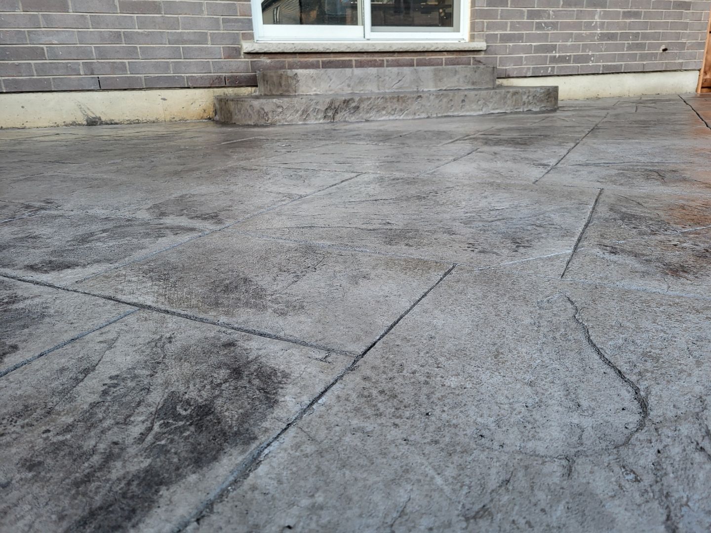 A brick building with a concrete patio in front of it