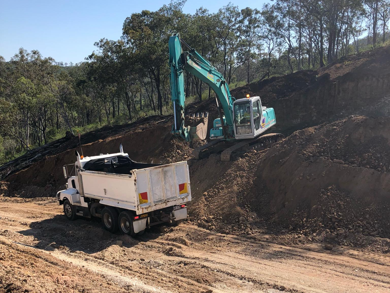 Excavator and dump truck