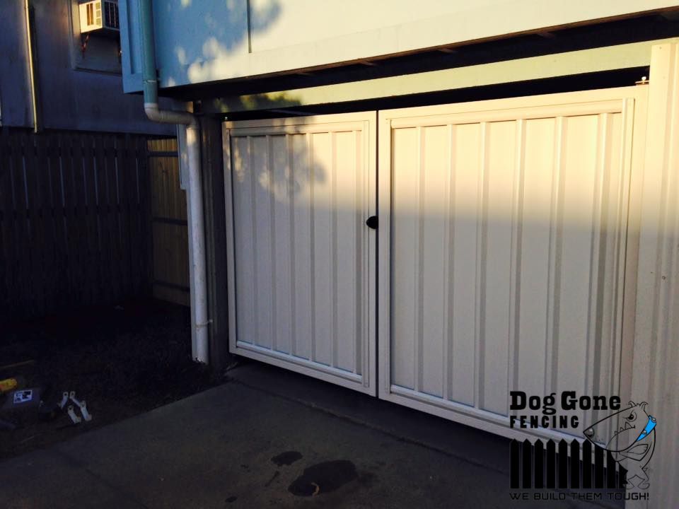 A White Garage Door — Dog Gone Fencing in Paget, QLD
