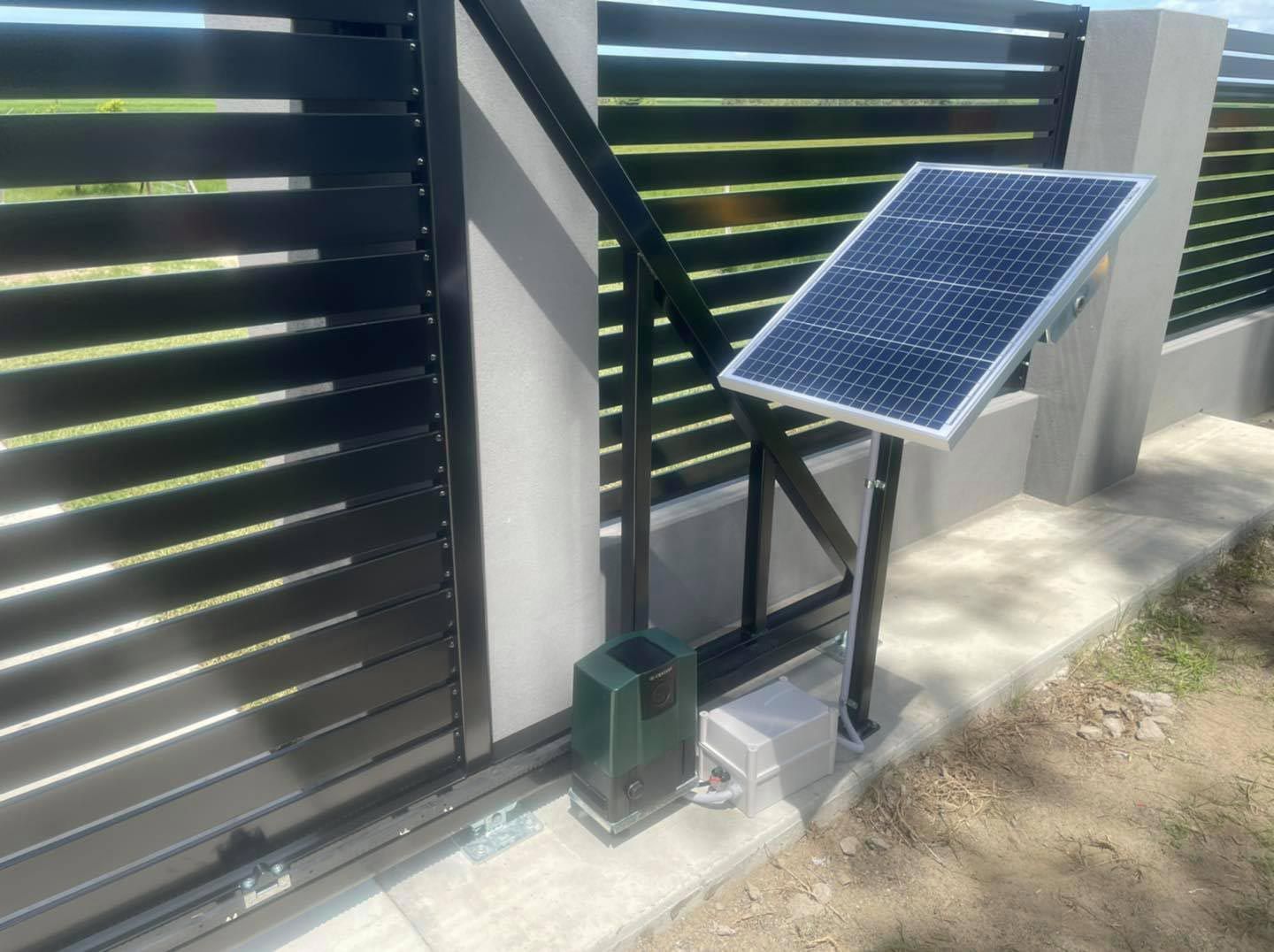 An Black Electric Gate Fence With Solar Panel — Dog Gone Fencing in Paget, QLD