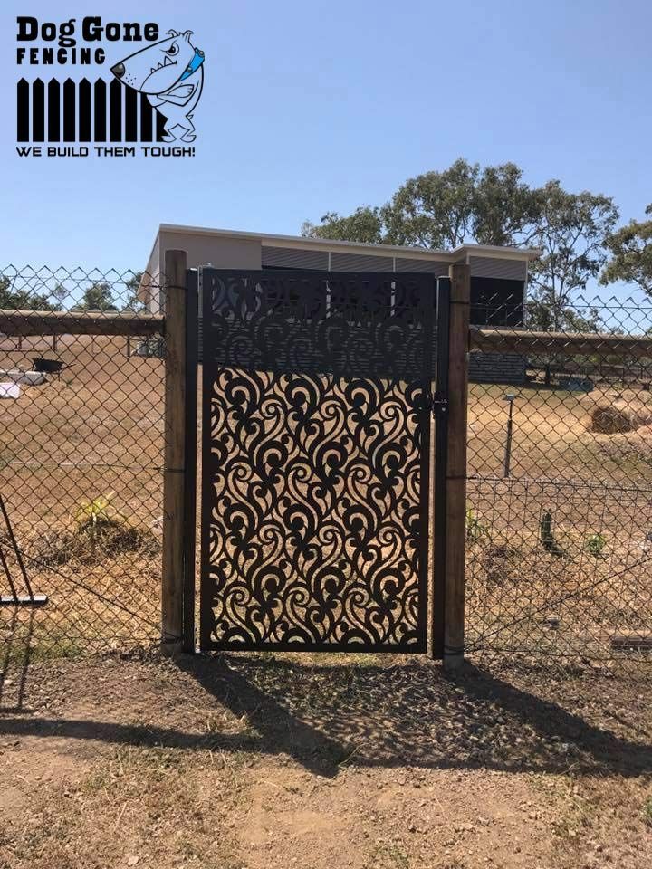 A Gate With A Pattern On It Is Sitting Next To A Chain Link Fence — Dog Gone Fencing in Mount Isa, QLD