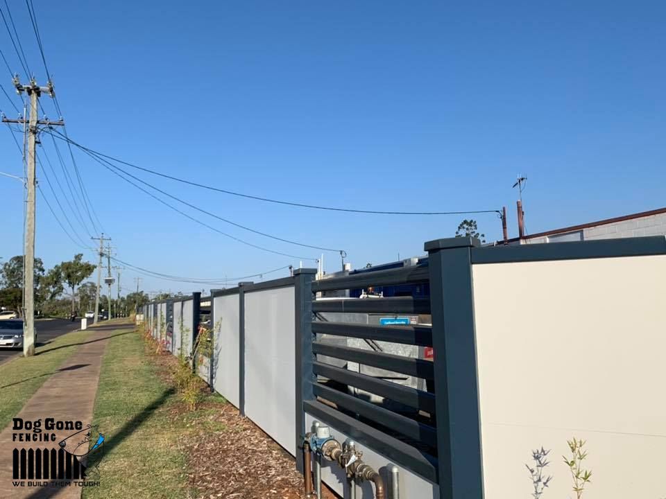 A Fence With A Lot Of Power Lines Behind It — Dog Gone Fencing in Paget, QLD