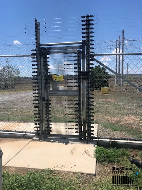 A Gate That Has A Bunch Of Wires Attached To It — Dog Gone Fencing in Paget, QLD