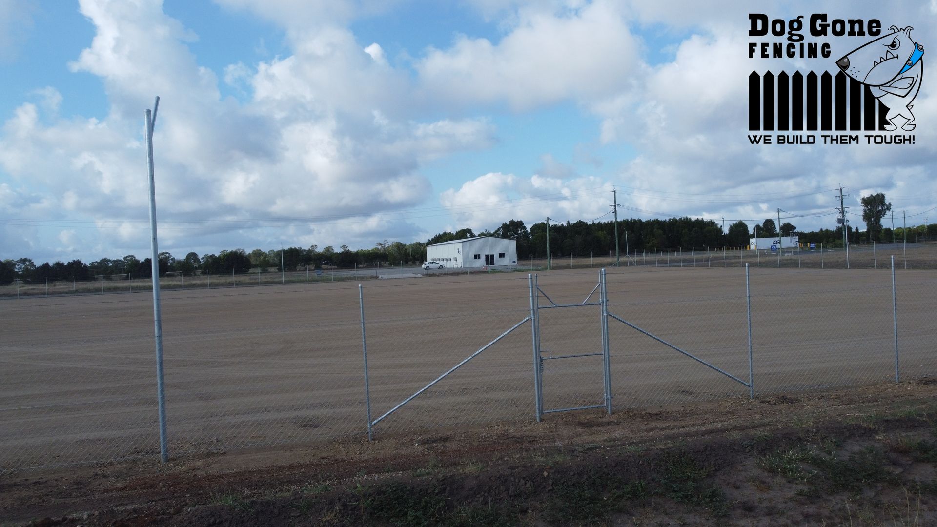 A Chain Wire Fencing Is On The Side Of A Dirt Field — Dog Gone Fencing in Paget, QLD