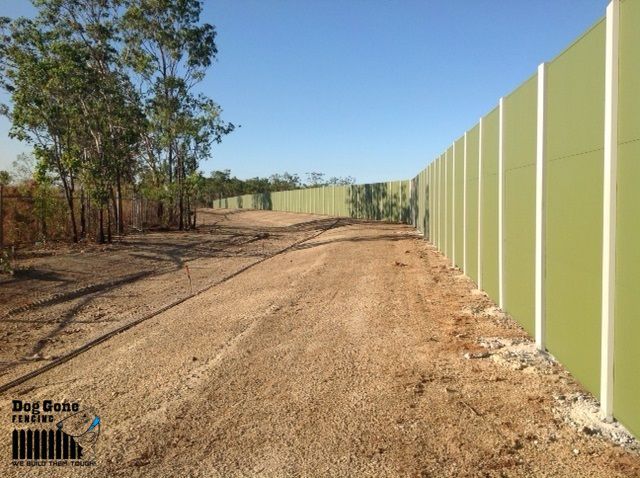 A Dirt Road With A Green Fence In The Background — Dog Gone Fencing in Paget, QLD