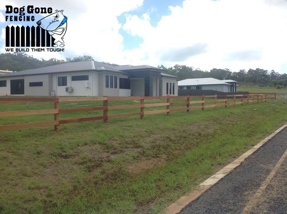 A House With A Wooden Fence In Front Of It That Says Dog Gone Fencing — Dog Gone Fencing in Paget, QLD