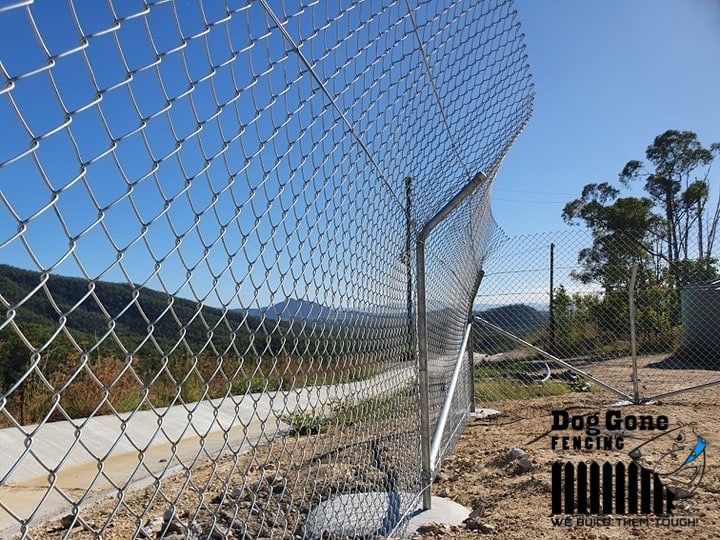 A Chain Link Fence Along A Dirt Road  — Dog Gone Fencing in Paget, QLD