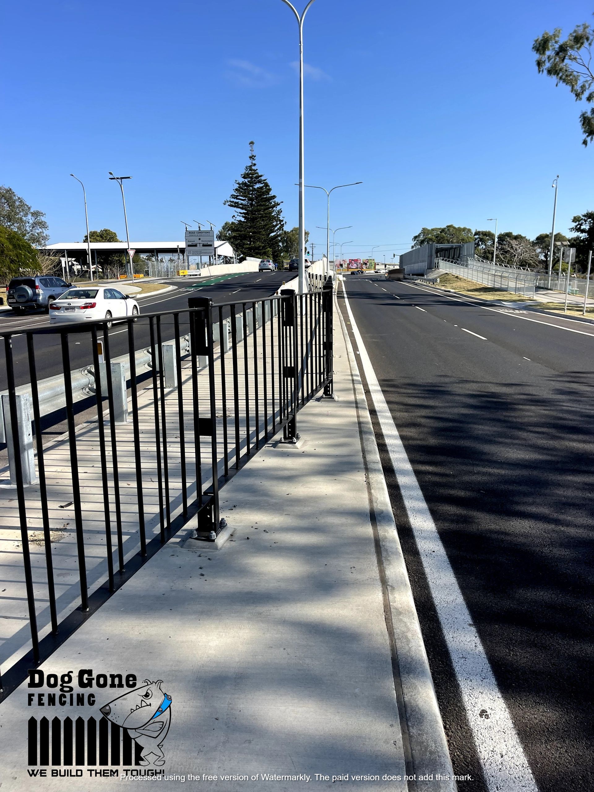 A Metal Fence Along The Side Of A Road — Dog Gone Fencing in Paget, QLD